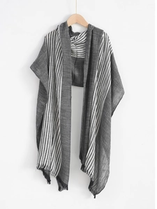 Detail showing high-quality black and white striped scarf texture with soft fringe tassels
