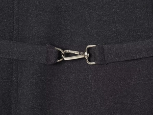 Macro view of silver lobster clasp and D-ring on soft dark grey fabric belt details