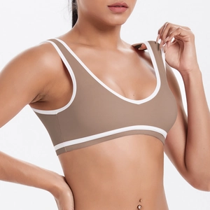 Close-up detail of dark brown sports bra with white piping trim and soft matte fabric