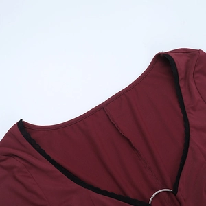 Detail of burgundy neckline with black scalloped lace and silver metal ring connector
