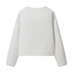 Detailed close-up of white floral quilted jacket showing intricate stitching and texture