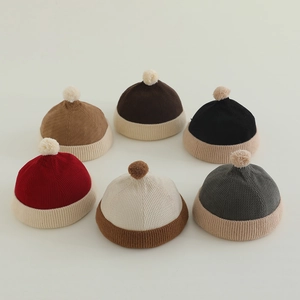 Variety of kids ribbed knit beanies with plush pom poms in six multi-color stylish designs