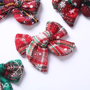 Détail de nœuds de Noël en lin avec motifs de flocons de neige en rouge et vert