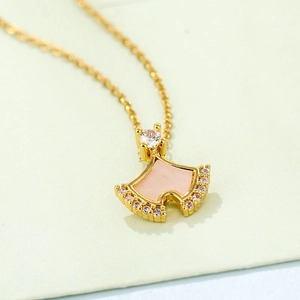 Golden ginkgo leaf necklace with pink shell inlay and sparkling zirconia accents