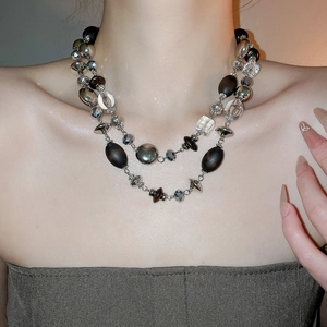 Close-up of double-layer vintage necklace with wood beads and silver geometric crystals