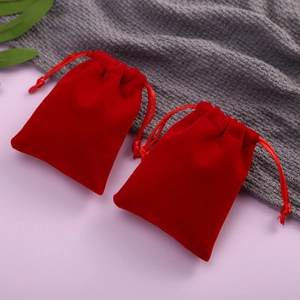 Elegant red velvet drawstring jewelry pouches for gift packaging and storage