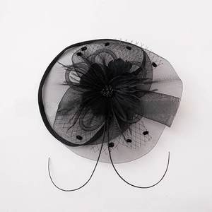 Detailed top view of black vintage bridal fascinator with mesh disk, feathers, and silk flower