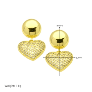 Detailed view of gold earrings with cubic zirconia heart charms and size measurements