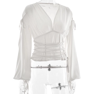 Détail du haut en satin blanc avec col en V, lacets à la taille et manches à cordon