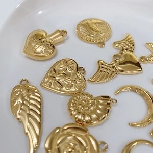 Golden titanium steel charms in heart, wing and coin shapes for DIY jewelry making