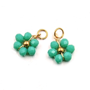 Detailed view of turquoise beaded flower pendants with golden metal connecting rings