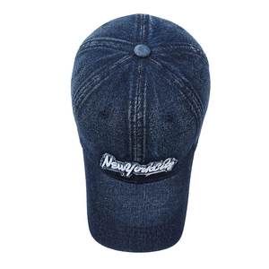 Vintage washed navy blue denim baseball cap with New York City embroidery on white background