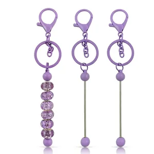DIY purple beaded keychain set with crackle glass beads and lobster clasp on white background