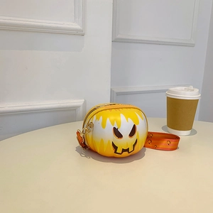 Detail of round smiley crossbody bag with melting monster face and pumpkin pattern strap