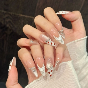 Handmade cat eye press-on nails with K9 crystals and pearl lace designs on long almond shape