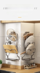 Detail of wall-mounted kitchen rack holding a cutting board and pot lid with drip tray