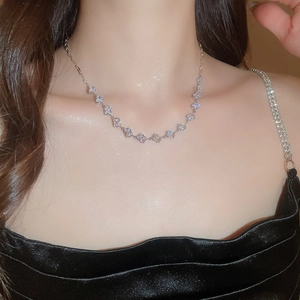 Close-up of elegant silver necklace featuring sparkling square zircon pendant on model