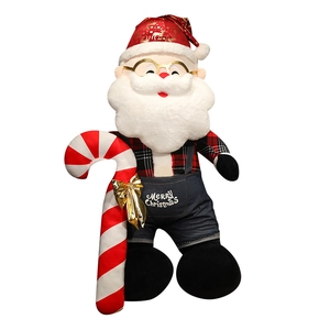 Giant Santa Claus plush doll in red plaid shirt and denim overalls with candy cane prop