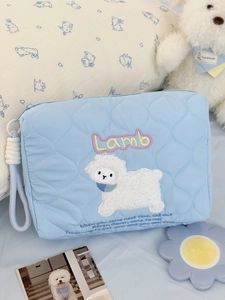 Light blue quilted storage bag with lamb embroidery and soft nylon zipper pull