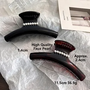 Elegant large 11.5cm hair claw clips in black and amber resin with faux pearl accents
