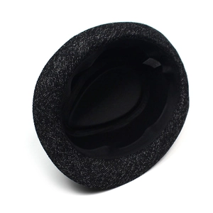 Detailed interior view of a black fedora hat with sweatband and fabric care label
