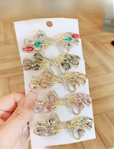 Detail of 5-piece crystal butterfly hair clips set with colorful rhinestones on gold alloy