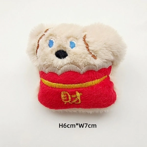 Detail showing 6cm mini plush dog toy wearing red festive outfit with embroidery