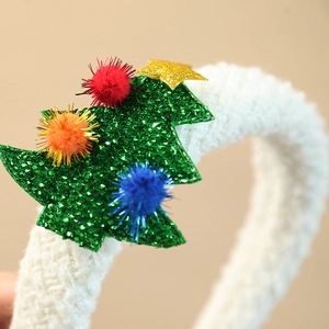 Cute Christmas headband featuring a green glitter tree with colorful pompoms and gold star