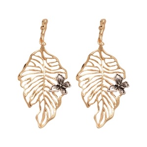 Golden monstera leaf drop earrings with silver butterfly accent in bohemian style