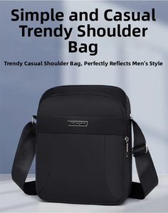 Close-up of waterproof black shoulder bag with silver logo and adjustable nylon strap