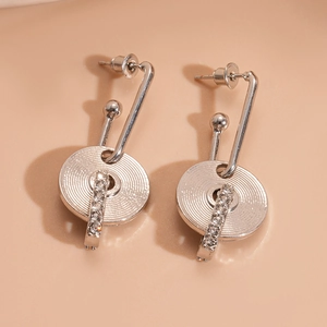 Detail of silver geometric round earrings with sparkling rhinestones and ball pendants