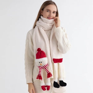Detail of white plush scarf featuring cute Santa Claus plush toy and festive red accents