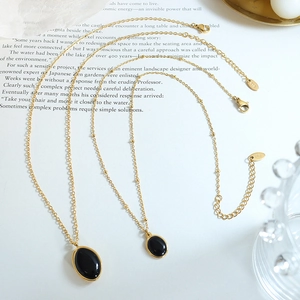 Vintage gold cat eye opal pendant necklace set on a decorative background book