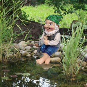 Garden gnome decoration featuring an old man fishing in a pond outdoor garden scene