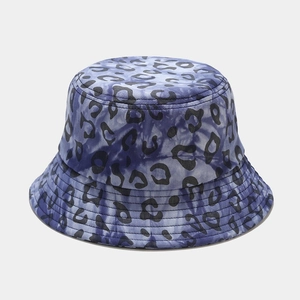 Detail of blue tie-dye bucket hat with black leopard print and reinforced stitching