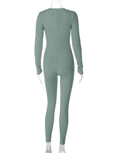 Detail of sage green ribbed knit jumpsuit showing slim fit back view on mannequin