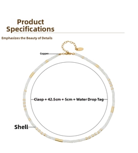 Detail of white shell bead necklace with gold brass spacers and extension chain
