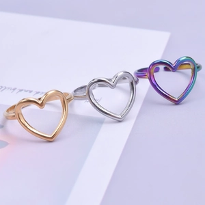 Three-piece set of heart-shaped open rings in gold, silver, and rainbow stainless steel