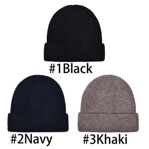 Selection of three warm wool knitted beanies in black, navy blue, and khaki colors.