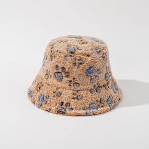 Detail of plush bucket hat featuring blue paw prints on thick brown faux fur fabric