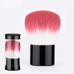 Portable retractable kabuki brush with pink gradient bristles and transparent storage tube