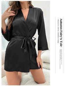Detail of elegant black short satin robe with v-neck and tie-up waist belt for women