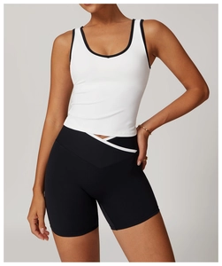 Detail of high-waist yoga shorts with cross V-waistband and contrast white piping trim