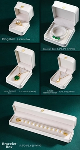 White jewelry storage boxes with gold crown accents for rings necklaces and bracelets