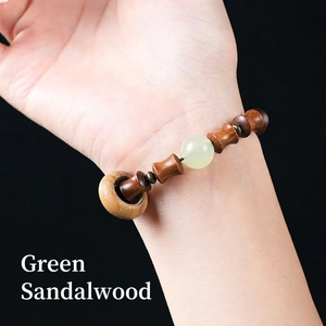 Minimalist green sandalwood bamboo joint bracelet with a luminous jade bead on wrist