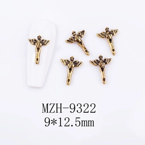 Macro view of retro alloy 3D angel cross nail art charms measuring 9x12.5mm on white base