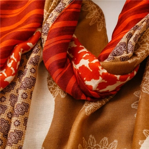 Macro detail of soft cotton-linen scarf showing floral patterns and woven texture