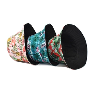Three tropical print bucket hats with flamingo and palm patterns for sun protection