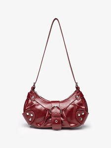 Red crocodile pattern hobo shoulder bag with silver rivets and buckle on white background