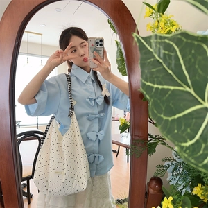 Mirror selfie showing the black and white polka dot canvas tote bag with casual outfit